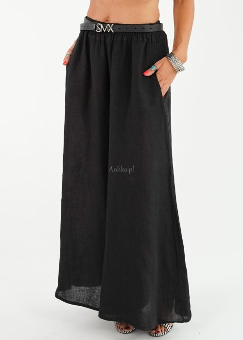 Czarne lniane spodnie damskie z bardzo szeroką nogawką i gumą w pasie, model z kieszeniami po bokach w swobodnej stylizacji.