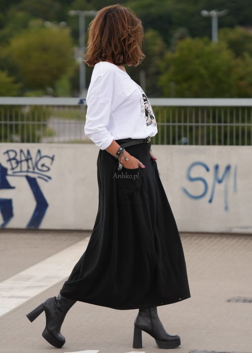 Czarne spódnico-spodnie maxi z elastycznym pasem i dużymi kieszeniami, zestawione z białą bluzką i czarnymi botkami na obcasie w miejskiej stylizacji.