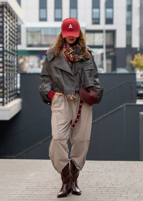 Beżowe spodnie oversize z obniżonym krokiem i dekoracyjnymi przeszyciami, luźny fason, miejska stylizacja damska.