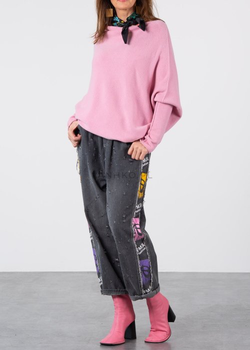 Pudroworóżowy sweter damski oversize o kroju nietoperzowym z asymetrycznym dołem, stylizacja z jeansami.