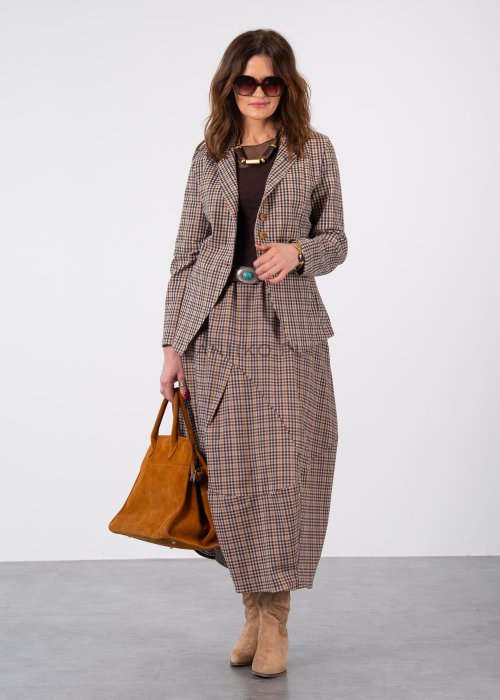 Beżowo-brązowa marynarka damska w drobną kratę z drewnianymi guzikami, zestawiona ze spódnicą w tym samym wzorze i paskiem w talii. Stylizacja w eleganckim, miejskim klimacie.
