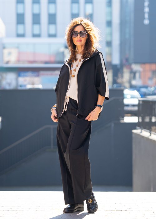 Czarne spodnie dresowe damskie z szeroką nogawką i elastyczną talią z troczkiem, stylizacja miejska