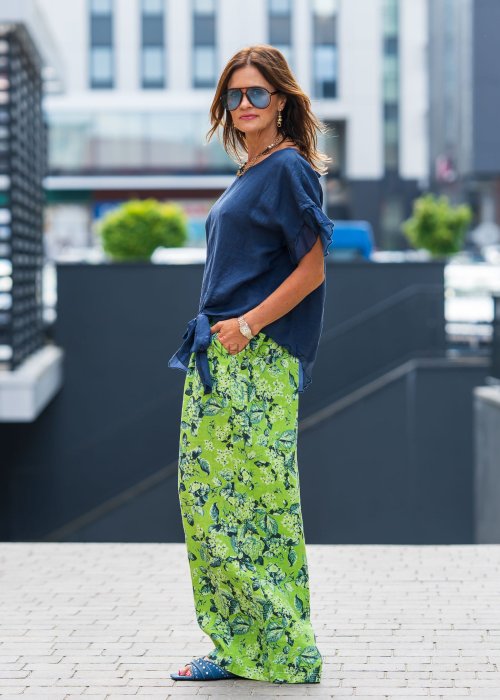Granatowa lniana bluzka damska z dodatkiem jedwabiu, falbaniastymi rękawami oraz asymetrycznym wykończeniem z ozdobnym wiązaniem. Elegancki model do codziennych stylizacji.
