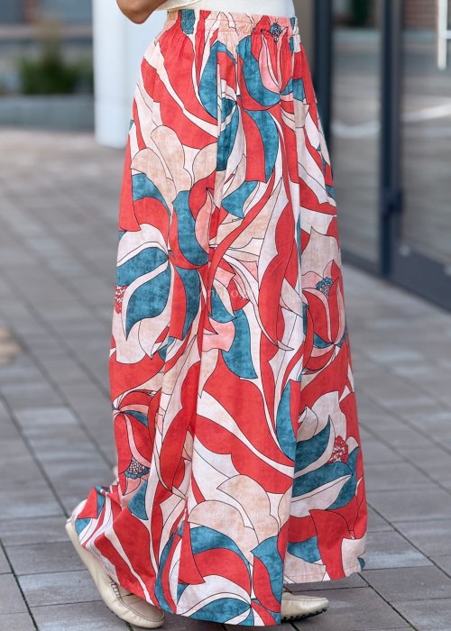 Szerokie spodnie damskie palazzo z wysokim stanem, wzór w duże kwiaty w odcieniach czerwieni, beżu i turkusu, styl boho