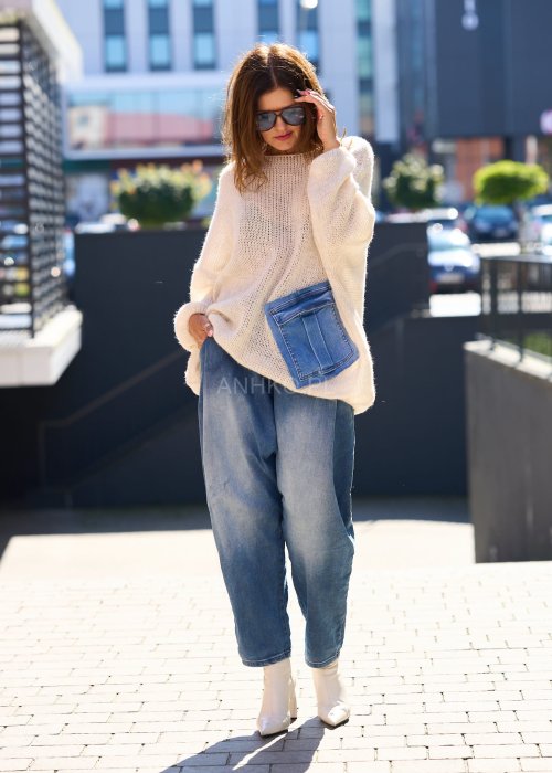 Beżowy sweter o luźnym, oversize’owym kroju, wykonany z przewiewnej, ażurowej dzianiny o grubym splocie.