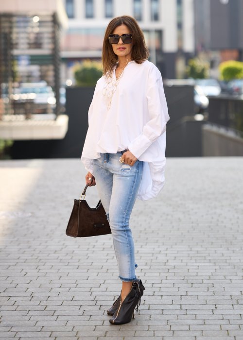 Jasnoniebieskie jeansy z przetarciami i dziurami na kolanach