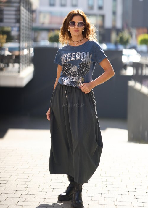 Antracytowa spódnica maxi typu bombka z elastycznym pasem i przeszyciami, zestawiona z czerwonym swetrem i czarnymi botkami w miejskiej stylizacji.