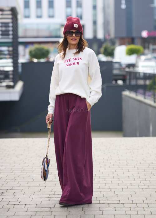 Śliwkowe spodnie damskie o szerokich nogawkach z elastyczną talią, luźny fason w nowoczesnej stylizacji miejskiej.