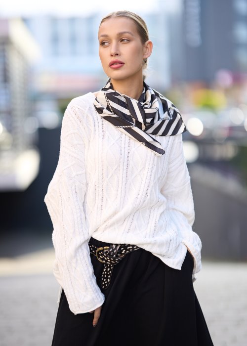 Biały sweter o grubym splocie z luźnym fasonem oversize, elegancka stylizacja damska