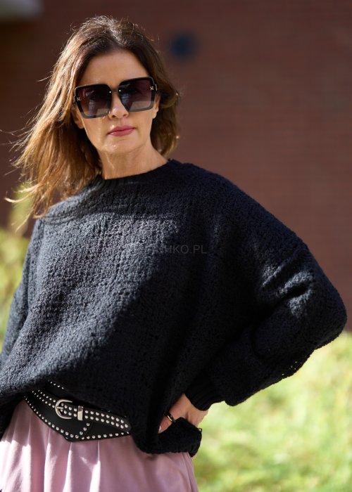 Czarny sweter z grubego splotu o luźnym kroju oversize, z długim rękawem i okrągłym dekoltem, styl miejski casual