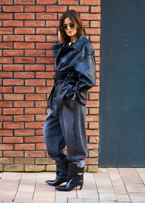 Antracytowe jeansy damskie o luźnym kroju z podwiniętymi nogawkami, stylizowane z czarnym topem i botkami na obcasie w miejskim looku.