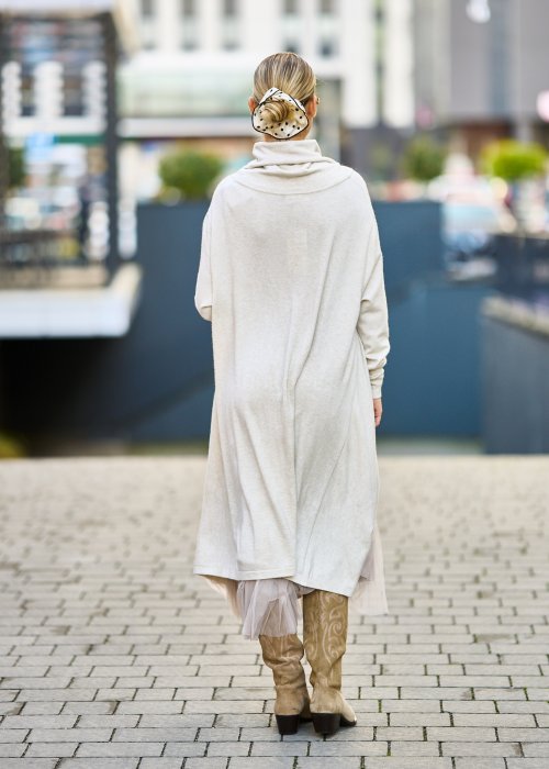 dwuczęściowa sukienka damska w kolorze kremowym, złożona z długiej, asymetrycznej tuniki z golfem i plisowanej spódnicy z tiulu