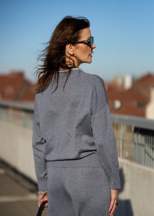 Niebieski sweter damski z dekoltem w serek i subtelnym połyskiem przy wykończeniu, miękki dzianinowy fason w stylu casual