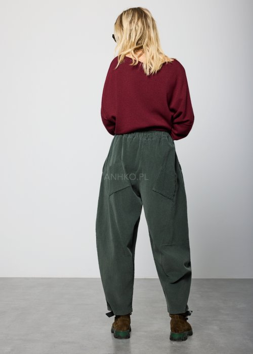 Ciemnozielone, luźne spodnie z miękkiej tkaniny z elastyczną talią i troczkiem, nogawki zwężane ku dołowi