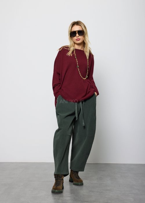 Ciemnozielone, luźne spodnie z miękkiej tkaniny z elastyczną talią i troczkiem, nogawki zwężane ku dołowi