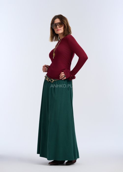 Bluzka z długim rękawem w głębokim odcieniu bordo. Fason jest smukły i blisko ciała, podkreślający sylwetkę, z gładką linią ramion i klasycznym, zabudowanym dekoltem.