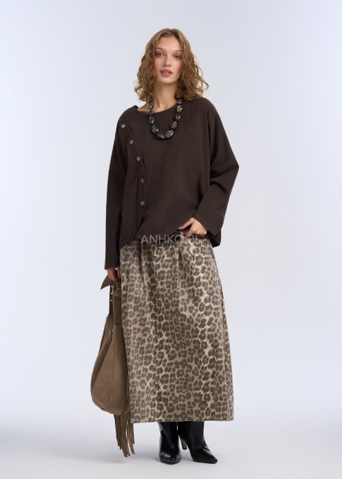 To luźna bluzka w kolorze ciemnego brązu, wykonana z lekkiego, miękko układającego się materiału.