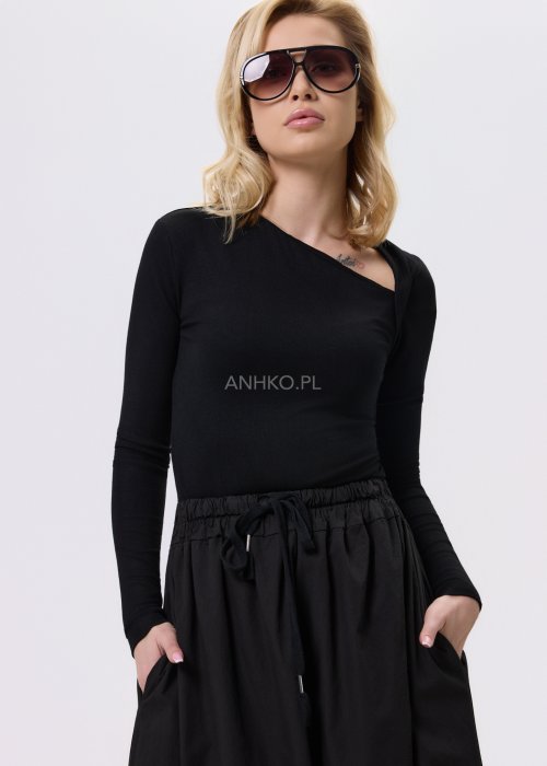 Czarna dopasowana bluzka damska z asymetrycznym dekoltem i długim rękawem, wykonana z elastycznego materiału, zestawiona z czarną spódnicą w nowoczesnej stylizacji.