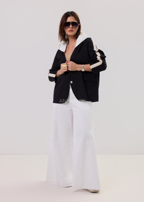 Czarna marynarka damska z kontrastowym kapturem i jasnymi lampasami na rękawach, o luźnym kroju, prezentowana w nowoczesnej stylizacji.