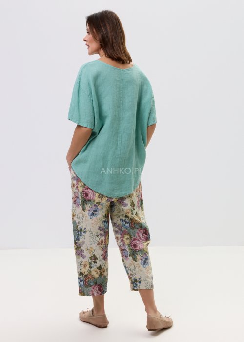 Luźna bluzka damska w kolorze mięty, z szerokim krojem i krótkim rękawem, zapewniająca swobodę noszenia.