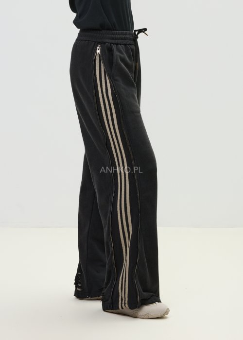 Damskie spodnie sportowe czarne z bocznymi paskami i suwakami