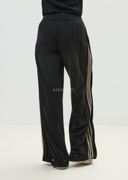 Damskie spodnie sportowe czarne z bocznymi paskami i suwakami