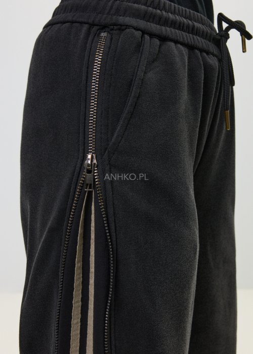 Damskie spodnie sportowe czarne z bocznymi paskami i suwakami
