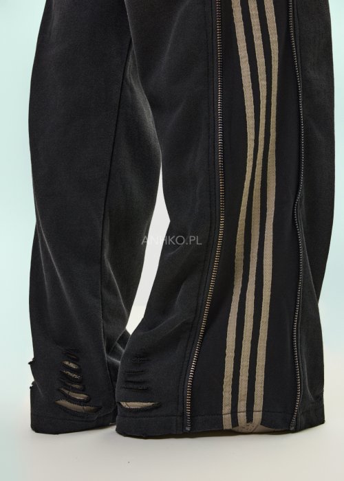 Damskie spodnie sportowe czarne z bocznymi paskami i suwakami