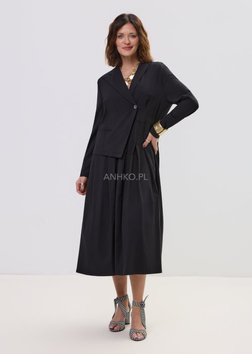 Czarna sukienka midi z kopertową górą i długim rękawem, o rozkloszowanym kroju, stylizowana z eleganckimi sandałami na obcasie.