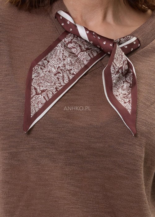 Brązowa bluzka dzianinowa damska z krótkim rękawem i wiązaną apaszką przy dekolcie, o klasycznym kroju, zestawiona z jasnymi jeansami w stylu casual.