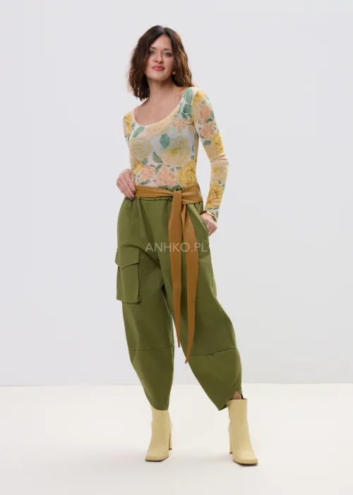 Szeroki pasek damski w kolorze karmelowym, wiązany w talii z długimi końcówkami, stylowy dodatek podkreślający sylwetkę w casualowej stylizacji.