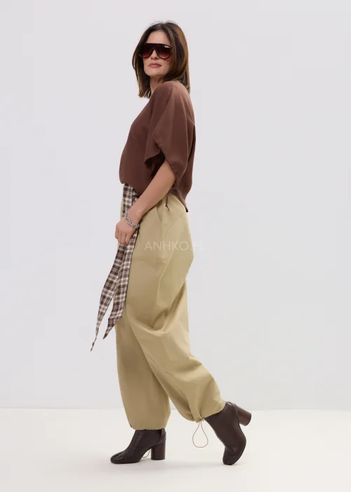 Brązowa bluzka damska o luźnym kroju z szerokimi rękawami i wiązaniami, lekki materiał, casualowa stylizacja.