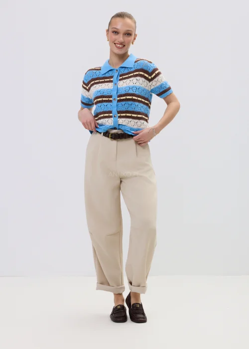 Ażurowy kardigan damski w paski w odcieniach błękitu i brązu z kołnierzykiem polo, stylizowany z beżowymi spodniami.