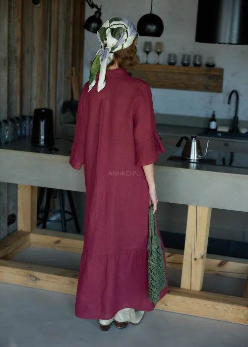 Bordowa lniana sukienka midi o luźnym kroju z kołnierzykiem i guzikami, z falbaną u dołu i rękawem 3/4, styl casual z chustką i torbą siatkową.