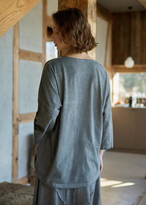 Grafitowa bluzka damska oversize z aplikacją gwiazdy i surowym wykończeniem, styl casual z szeroką spódnicą w naturalnym klimacie.