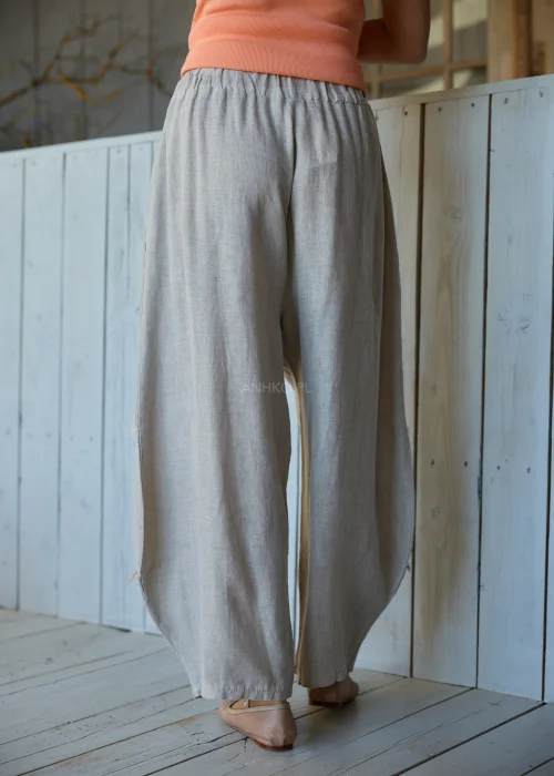 Spodnie damskie w kolorze taupe z dodatkiem lnu o luźnym kroju, z elastyczną talią i dekoracyjnymi przeszyciami, w stylu casualowym.