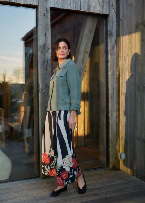 Spodnie damskie w czarno-białe pasy z kwiatowym nadrukiem, szerokie nogawki i wysoki stan, elegancki, lekko oversize fason.