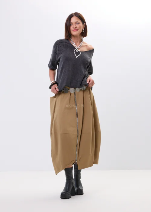 Spódnica midi w karmelowym odcieniu o asymetrycznym, lekko oversize’owym fasonie. Model z efektownymi przeszyciami i dużą kieszenią po boku nadaje stylizacji nowoczesnego charakteru i swobodnego ruchu.