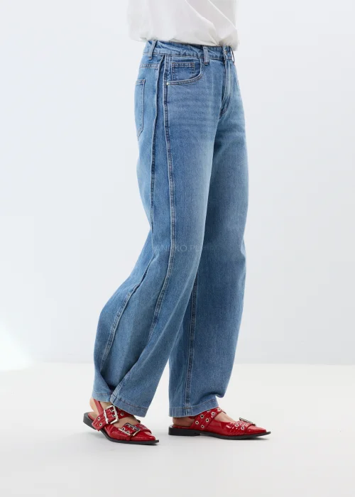 Niebieskie jeansy damskie o szerokim kroju z wysokim stanem i luźnymi nogawkami. Model wide leg z delikatnym spraniem.