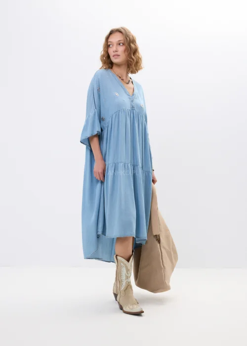 Jasnoniebieska sukienka jeansowa oversize z falbanami i dekoltem V. Zwiewny model z ozdobnymi detalami idealny do boho i casualowych stylizacji.