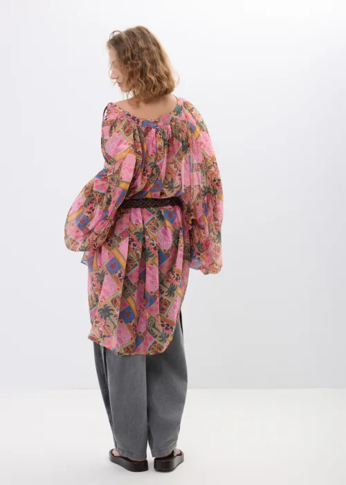 Bluzka damska oversize w stylu boho z multikolorowym printem patchworkowym w odcieniach różu, pomarańczu i brązu. Zwiewny model z szerokimi rękawami oraz wiązaniem w talii świetnie uzupełnia casualowe i artystyczne stylizacje.