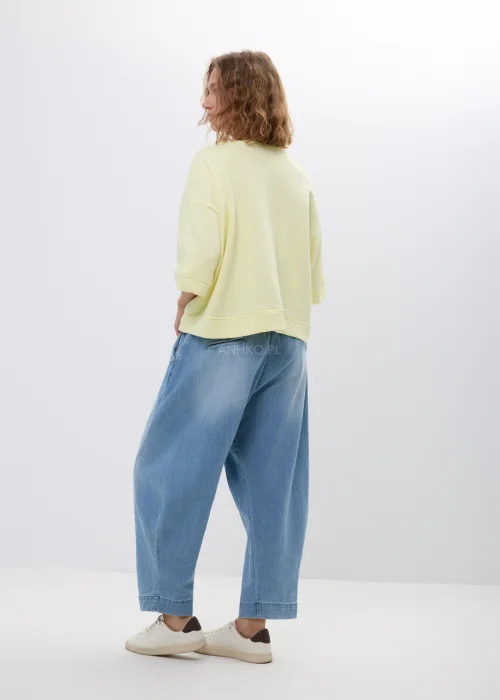 Żółta bluza oversize z krótkim rękawem i ściągaczem u dołu. Luźny fason w pastelowym odcieniu, idealny na co dzień.