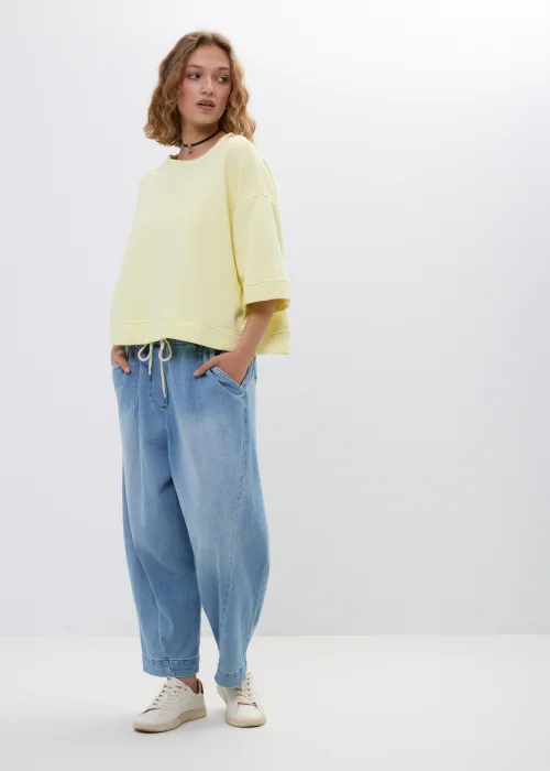 Żółta bluza oversize z krótkim rękawem i ściągaczem u dołu. Luźny fason w pastelowym odcieniu, idealny na co dzień.