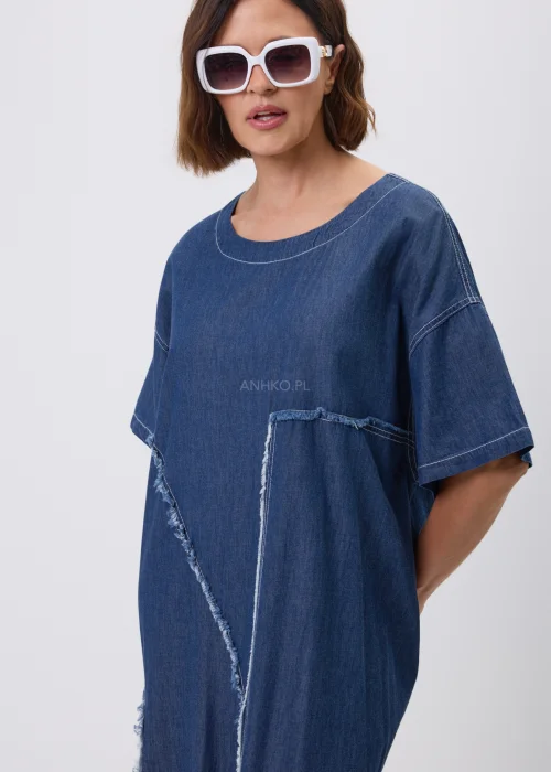 Jeansowa sukienka maxi oversize z krótkim, szerokim rękawem, ozdobiona dekoracyjnymi przeszyciami oraz naszywanymi aplikacjami w kształcie okręgów z postrzępionym wykończeniem. Luźny fason zapewnia wygodę i tworzy nowoczesną, casualową stylizację.