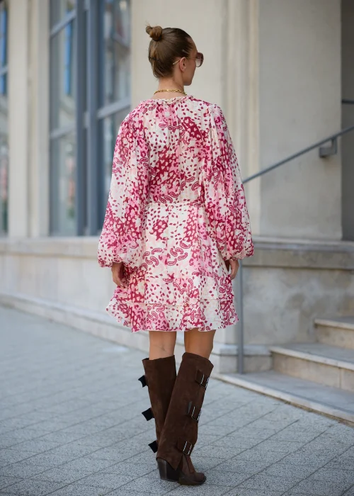 Sukienka mini boho w odcieniach różu i kremu, zwiewny fason z falbaną i wiązaniem w talii – stylizacja z kowbojkami.