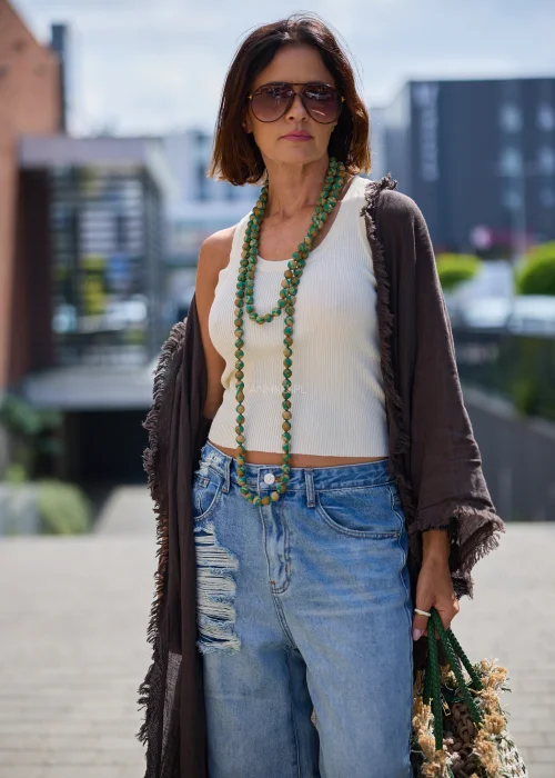 Damski naszyjnik Verdeya z drewnianymi kulami pokrytymi zielono-beżową wzorzystą tkaniną. Długi model zakładany przez głowę w stylu boho i etno.