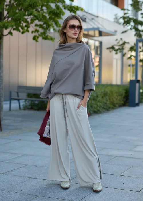 Bluzka damska oversize taupe z asymetrycznym dekoltem, szerokimi rękawami 3/4 i luźnym fasonem.