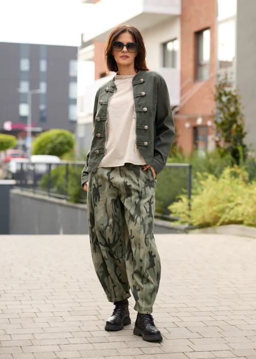 Spodnie damskie oversize w militarny wzór moro w odcieniach khaki i ciemnej zieleni, z szerokimi nogawkami o swobodnym fasonie.