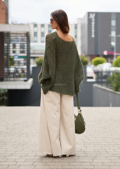 Sweter damski oversize khaki o ażurowym splocie, z szerokim dekoltem, obniżoną linią ramion i luźnym fasonem.